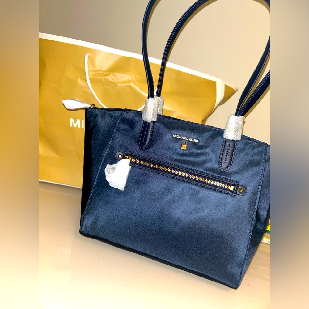 Brand NEW Michael Kors tote bag. Navy Blue and gold. Really chic and cute.